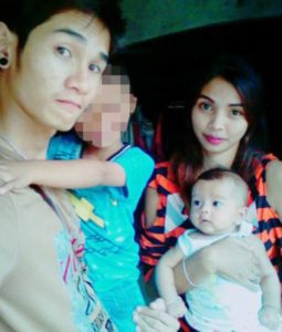 VIRAL PRESS - NEWS COPY - WITH VIDEO AND PICTURES (07771706292 / +66896682190) CAPTION: Father Wuttisan Wongtalay, 20, with 11-month-old daughter ëBetaí who he hanged live on Facebook along with himself after a jealous row with his girlfriend Jiranuch Trirat, 21, pictured with an unrelated young male relative NEWS COPY: An evil father hanged himself and his 11-month-old daughter live on FACEBOOK after a row with his girlfriend. Wuttisan Wongtalay, 20, accused partner Jiranuch Trirat, 21, of cheating on him before disappearing later with their child Beta yesterday (Mon) afternoon. The twisted father climbed a building and opened the Facebook live stream before looping a rope round his daughterís neck and throwing her off the edge. He puts a noose around his own neck but clambers back over the side with his daughter - who is still alive - before repeating it again. Shockingly, frantic partner Jiranuch saw the video at 6.30pm and called police who found the pair hanging from an abandoned building in Phuket, Thailand. The heartbroken mother told officers that she had fled the home earlier that morning after Wuttisan had threatened to kill her. She said he had checked her phone at 3am and he accused her of having an affair before flying into a jealous rage. Jiranuch went home later that day and rang her boyfriend but could not reach him - before logging on to Facebook and seeing the horrific video. Lt Col Sanit Nookhong from the Thai Royal Police said the murder suicide was ëían actor of jealouslyíí and Jiranuch was being consoled by family and friends. He said: ëíWe had an emergency call from Ms. Trirat and launched a search. We found the bodies of the father and daughter. ëíWe then checked the video of the man. He had done it before we arrived so there was no way for us to reach them. ëíThe man had an argument with his girlfriend. He was jealous and thought that she had other boyfriends. ëíThe video was posted at 5.45pm and we had the call at 6.30pm.'' ENDS